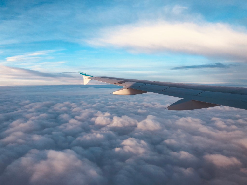 Clouds in the sky, left wing of an A320 aircraft. 