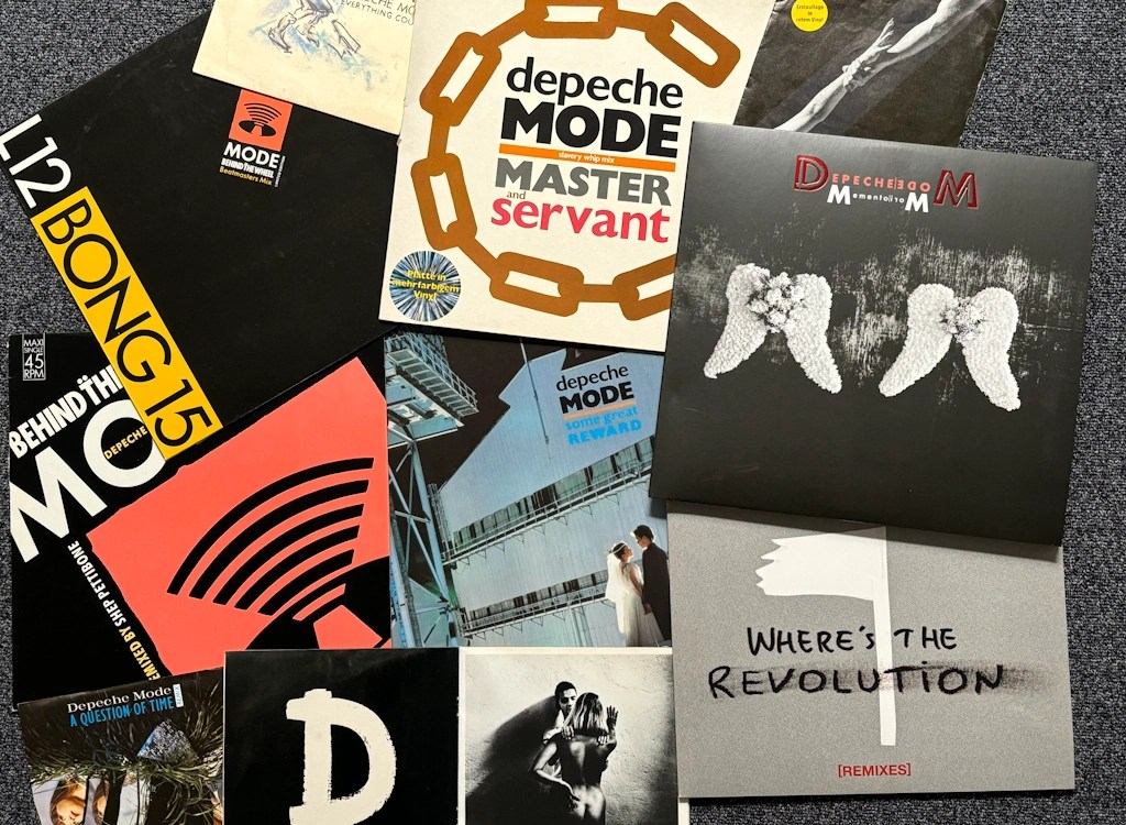 Collection of Depeche Mode vinyl records and singles featuring iconic album covers such as Master and Servant, Behind the Wheel, A Question of Time, and Where’s the Revolution.